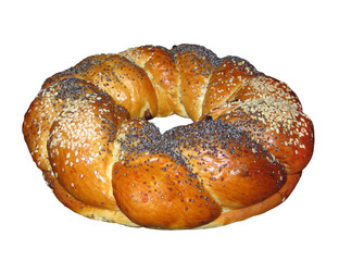 There is a round sweet bun sprinkled with poppy seeds and sesame seeds with a hole. White background. Isolated.