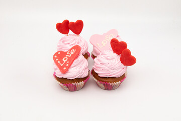 Valentine's Day. Cupcakes with hearts on a white background for Valentine's Day.