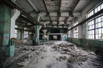 Abandoned factory. Large empty industrial hall with garbage