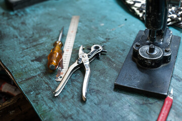 Closeup shot of leather tools on a craftsman table