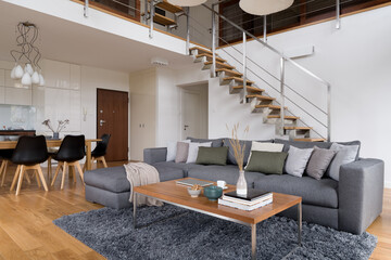Elegant and spacious living room with stairs