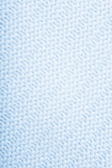 Close up of blue knitted textured background. Trendy color.