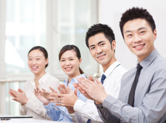 Young Business people applauding in office, smiling 