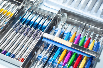 Various dental curettes in metal boxes. Various sets with dentist curettes. New multi-colored...