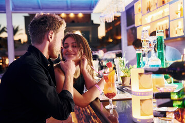 At the bar. Happy young couple is together on their vacation
