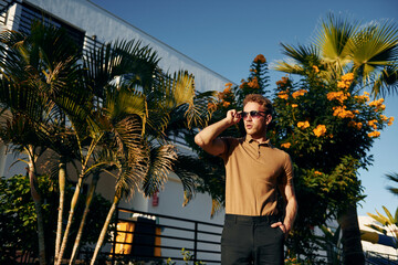 Beautiful nature. Young man is outdoors at sunny daytime. Concept of vacation