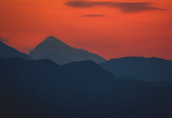 Sunrise behind big mountain silhouette, lake bled Slovenia alps