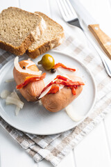 Pickled sausages with onion and red pepper. Marinated food.