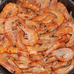 Fried shrimp in a pan, square frame