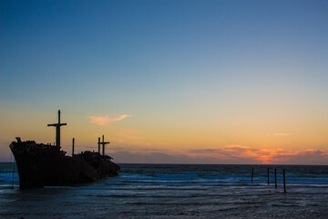 The wrecked ship is sitting on the shore