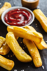 Big french fries. Fried potato chips with ketcheup.