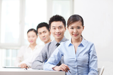 Group of business people sitting at conference table 