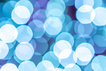 Bokeh background Blue glitter abstract lights. Festive blur. Defocused winter backdrop.