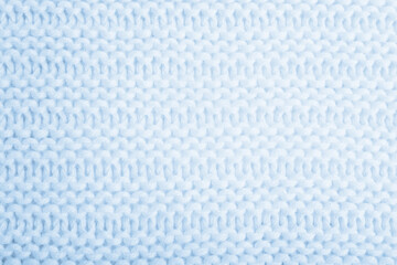 Close up of blue knitted textured background. Trendy color.