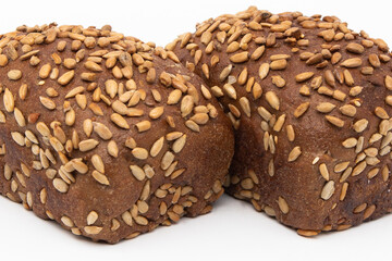 Bread. A whole loaf of bread with seeds on a white background .