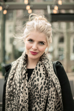 Fashionable woman smiling while standing outdoors