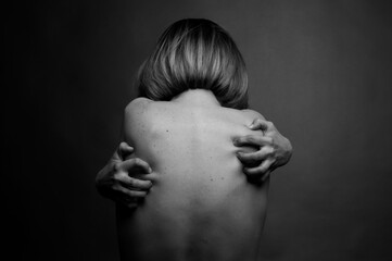 Black and white photo of a nude female back. Art and abstraction.