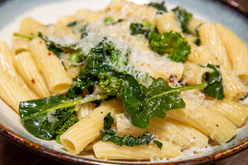 A delicious plate of Pasta with peas and herbs tops off with grated cheese.