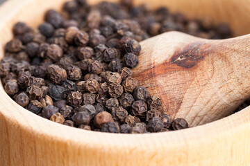 black peas pepper on an old wooden table