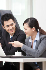 Group of businesspeople discussing working on computer