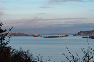 Towing of ships in perfectly calm weather with a nice sunset in progress