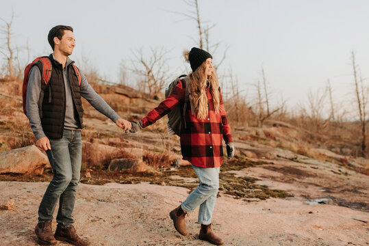 Young couple holding hands during autumn hike