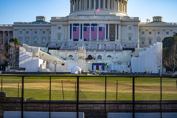 US Capitol Building protected by nonscalable fence through Biden's inauguration during construction.