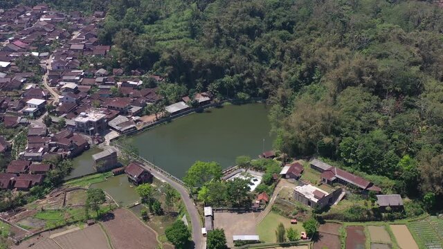 Lake Bleder is a natural artificial lake with many trees around its green water