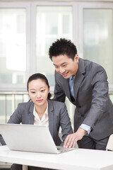 Business man and business woman working on computer