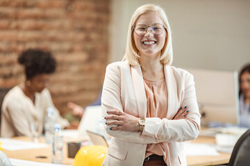 Portrait of young white woman in a busy modern workplace. Face of beautiful woman on the background...