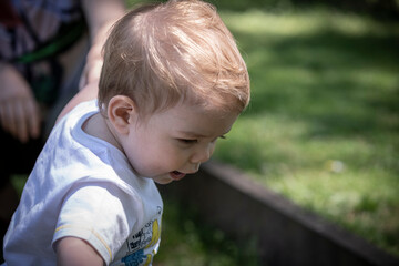 blonde baby boy playing in the park