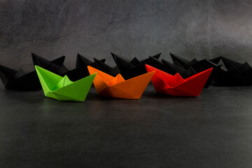 Red, orange, green and black color paper boats. Black history month concept. Flat lay. Copy space.