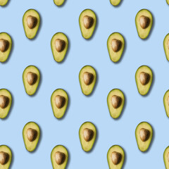 Avocado pattern on light blue background. Green avocadoes, minimal flat lay style. seamless pattern.