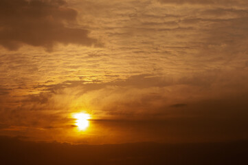 Fototapeta na wymiar Dramatic winter sunrise with cloudy orange sky in winter