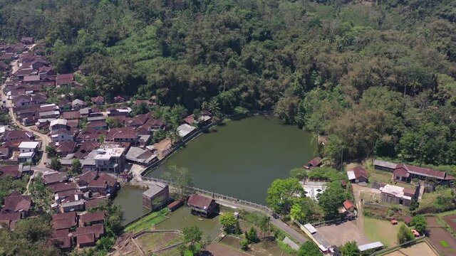 Lake Bleder is a natural artificial lake with many trees around its green water