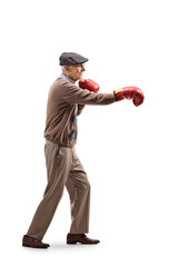 Full length profile shot of an elderly manexercising with boxing gloves