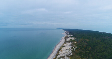 Fototapeta na wymiar Curonian Spit, a saber-shaped sandy land strip separating the Curonian Lagoon from the Baltic Sea., Kaliningrad, Russia. Aerial panoramic view. Skyscrapers from the Drone, autumn 