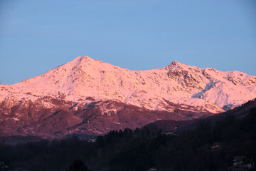 Naklejka premium profile of a Piedmont alp overlooks the Po Valley immersed in a pink sunset