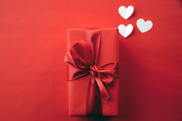 Red gift box on red background, valentine's day gift, special occasion