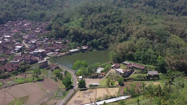 Lake Bleder is a natural artificial lake with many trees around its green water