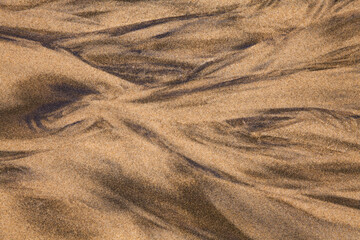 Patterns in wet sand at low tide
