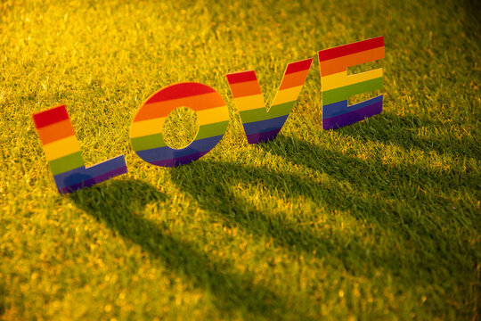LGBT love letters on grass prede sunset