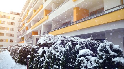 Fragment of modern apartment building on the background of winter  during a heavy snowfall