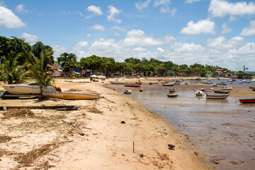 Fishing boats at Coroa Beach (Praia Corcoa) at low tide in the town of Itacare, Brazil