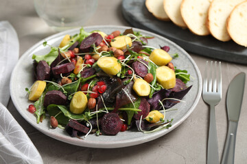 Delicious fresh carrot salad served on grey table, closeup
