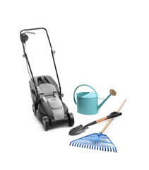 Modern electric grass cutter and gardening tools on white background