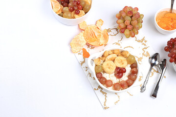 Useful breakfast, fruit salad with grapes, tangerines, banana and slimming jam. The concept of healthy and natural food, detox diet, lifestyle, promotes weight loss, selective focus,