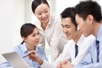 Group of businesspeople discussing working on computer