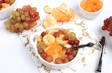 Fruit salad with grapes, tangerines, banana and jam for weight loss. Useful breakfast, Healthy and natural food concept, detox diet, lifestyle, weight loss, selective focus,