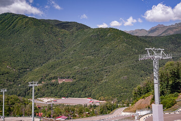 View of the mountains, overgrown with dense deciduous and coniferous forests, beautiful at any time of the year, with modern transport and economic communications for the active recreation of people